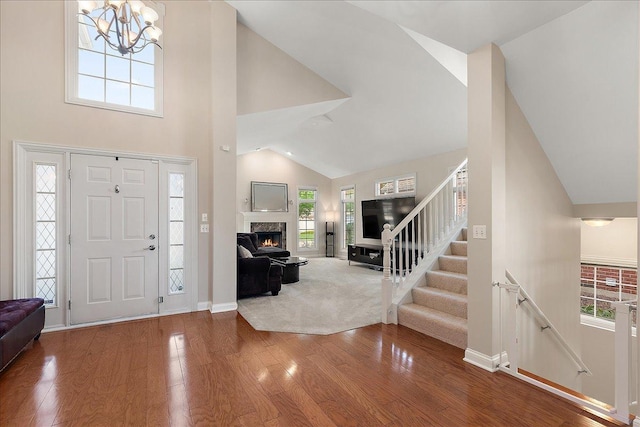 13093 Timber Ct Unit 61, Palos Heights, IL 60463 - foyer entrance with wood finished floors, high vaulted ceiling, a chandelier, a fireplace, and stairs