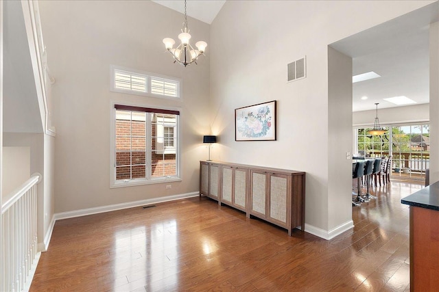 13093 Timber Ct Unit 61, Palos Heights, IL 60463 - empty room with wood finished floors, a chandelier, and high vaulted ceiling