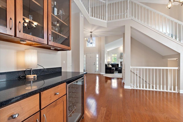 13093 Timber Ct Unit 61, Palos Heights, IL 60463 - kitchen with wine cooler, brown cabinetry, dark wood-style floors, a chandelier, and glass insert cabinets