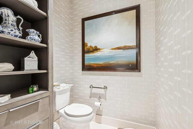 118 E Erie St Unit 21D, Chicago, IL 60611 - half bathroom featuring wallpapered walls and toilet