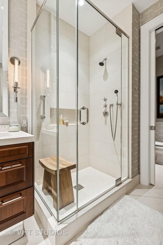 118 E Erie St Unit 21D, Chicago, IL 60611 - full bath with vanity, a stall shower, and tile patterned flooring
