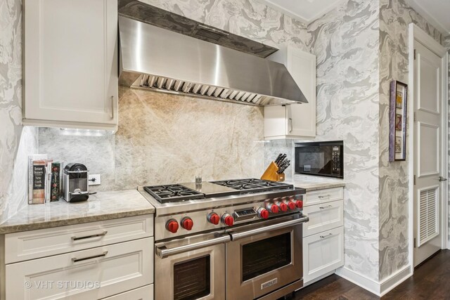 118 E Erie St Unit 21D, Chicago, IL 60611 - kitchen featuring double oven range, extractor fan, black microwave, wallpapered walls, and backsplash