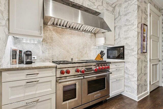 118 E Erie St Unit 21D, Chicago, IL 60611 - kitchen featuring double oven range, exhaust hood, black microwave, wallpapered walls, and dark wood-style floors