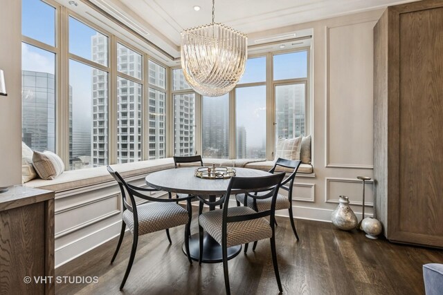 118 E Erie St Unit 21D, Chicago, IL 60611 - dining space featuring dark wood-style floors, a chandelier, and baseboards