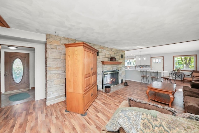 1423 N River Rd, Mchenry, IL 60050 - living area featuring light wood-style flooring and a stone fireplace