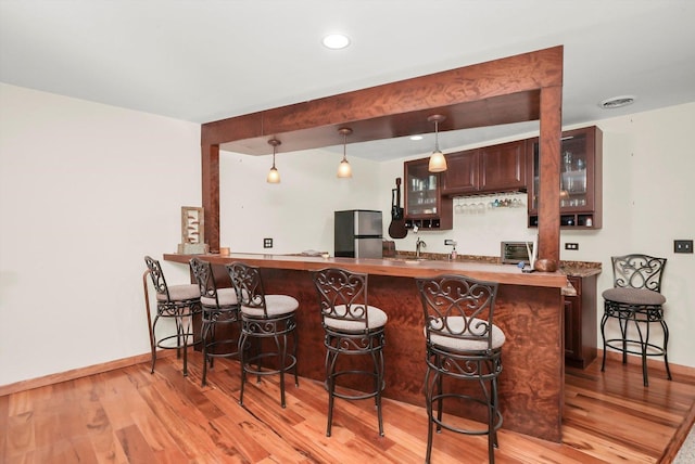1423 N River Rd, Mchenry, IL 60050 - indoor wet bar with freestanding refrigerator, light wood-type flooring, baseboards, decorative light fixtures, and recessed lighting