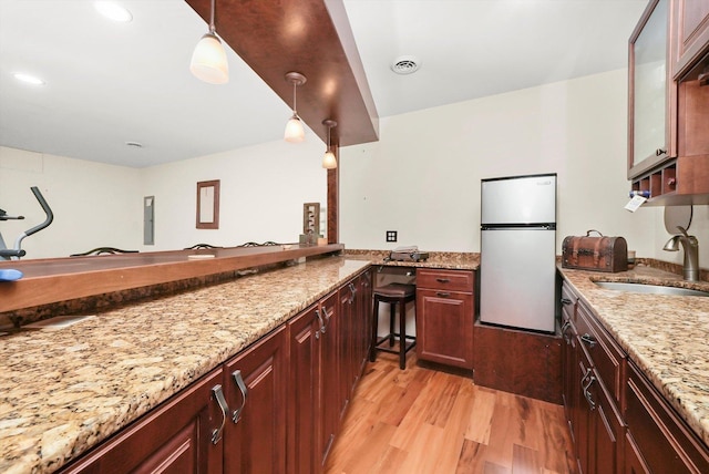1423 N River Rd, Mchenry, IL 60050 - kitchen with freestanding refrigerator, a sink, light wood-type flooring, light stone counters, and recessed lighting