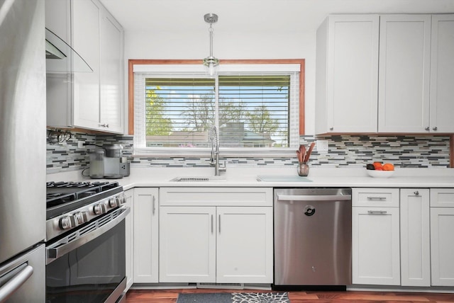 1423 N River Rd, Mchenry, IL 60050 - kitchen with stainless steel appliances, tasteful backsplash, light countertops, a sink, and white cabinetry