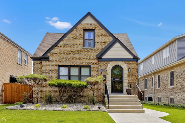 10407 S Artesian Ave, Chicago, IL 60655 - tudor home featuring brick siding, central AC unit, and a shingled roof