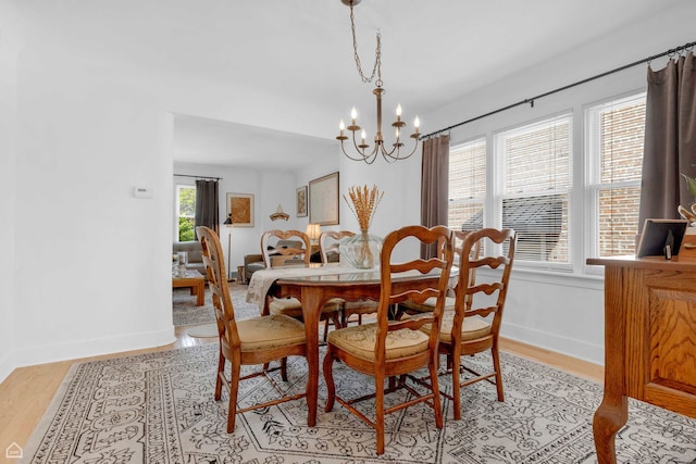 10407 S Artesian Ave, Chicago, IL 60655 - dining space with a chandelier, baseboards, and light wood-style floors