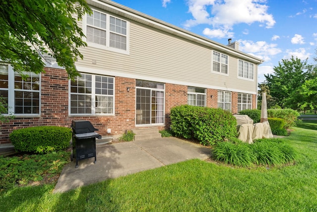 7324 Chestnut Hills Dr, Burr Ridge, IL 60527 - rear view of house with a chimney, a lawn, brick siding, and a patio area