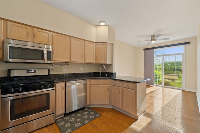7324 Chestnut Hills Dr, Burr Ridge, IL 60527 - kitchen with appliances with stainless steel finishes, a sink, light brown cabinetry, a peninsula, and light wood-type flooring