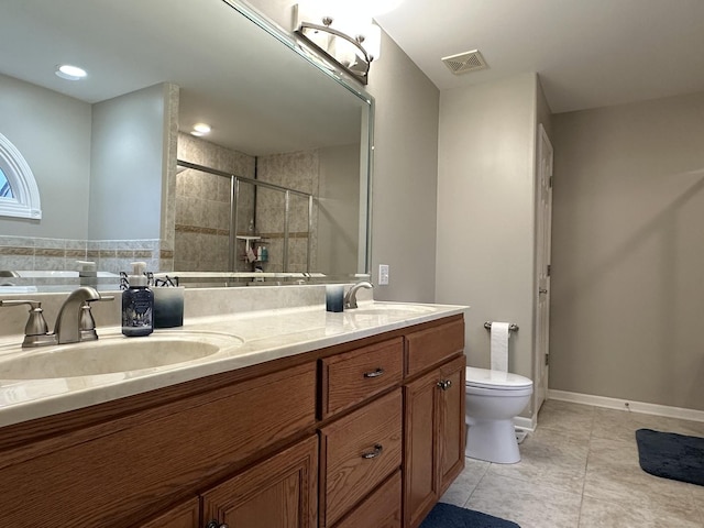 445 Spring Park Loop, Bourbonnais, IL 60914 - bathroom featuring toilet, double vanity, a shower stall, tile patterned flooring, and baseboards