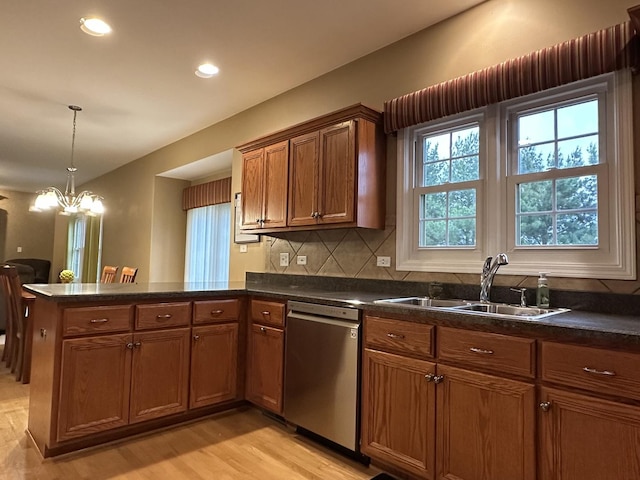 445 Spring Park Loop, Bourbonnais, IL 60914 - kitchen featuring dishwasher, a sink, a peninsula, brown cabinets, and light wood-style flooring