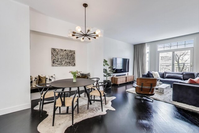 335 E Cullerton St, Chicago, IL 60616 - dining space featuring a chandelier, baseboards, and wood finished floors