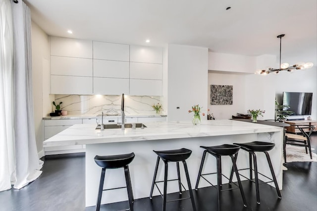 335 E Cullerton St, Chicago, IL 60616 - kitchen with modern cabinets, a sink, white cabinets, decorative backsplash, and light stone countertops