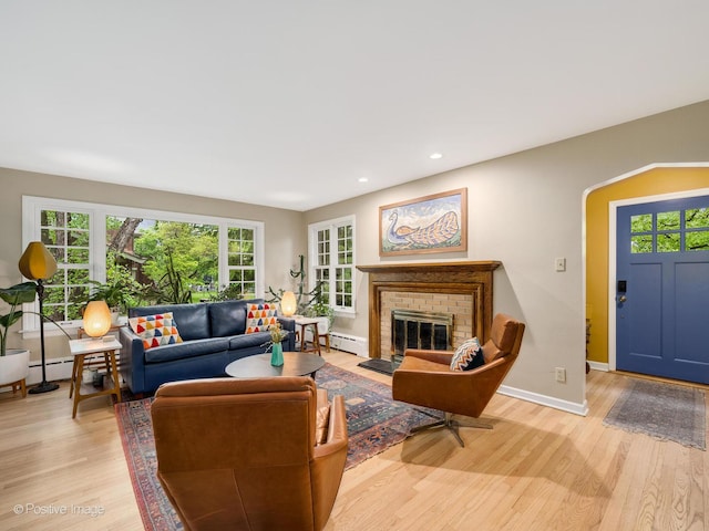 411 Linden Ave, Oak Park, IL 60302 - living room with a baseboard radiator, light wood-style flooring, a fireplace, baseboards, and recessed lighting