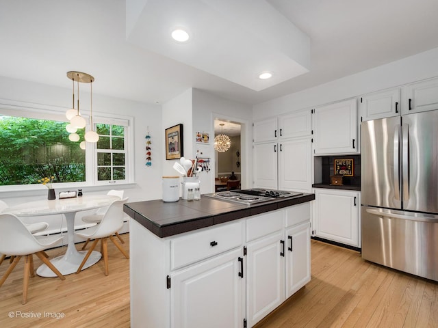 411 Linden Ave, Oak Park, IL 60302 - kitchen featuring freestanding refrigerator, dark countertops, light wood-style floors, white cabinetry, and electric cooktop