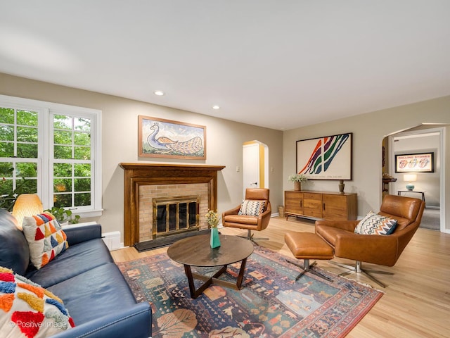 411 Linden Ave, Oak Park, IL 60302 - living room with arched walkways, a brick fireplace, recessed lighting, and wood finished floors