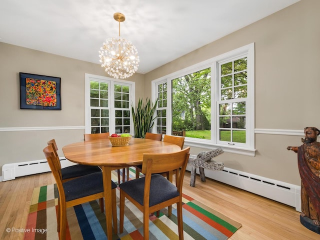 411 Linden Ave, Oak Park, IL 60302 - dining area with a baseboard heating unit, wood finished floors, and a chandelier