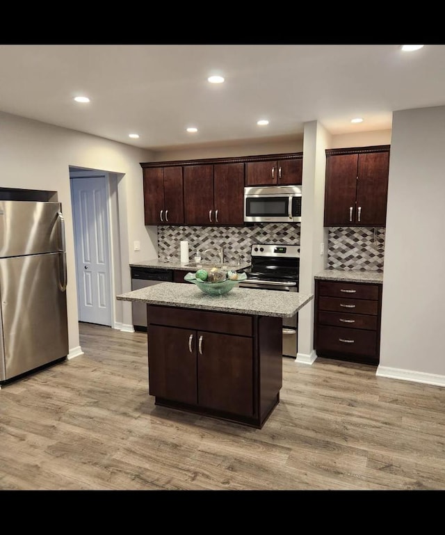 720 N Western Ave Unit 10, Park Ridge, IL 60068 - kitchen featuring appliances with stainless steel finishes, light wood-style floors, decorative backsplash, dark brown cabinets, and recessed lighting
