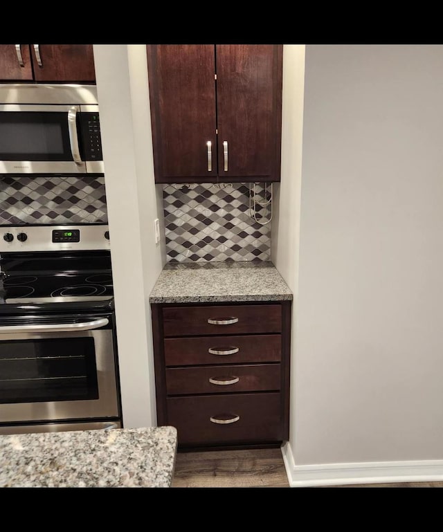 720 N Western Ave Unit 10, Park Ridge, IL 60068 - kitchen with appliances with stainless steel finishes, tasteful backsplash, dark brown cabinetry, wood finished floors, and light stone countertops