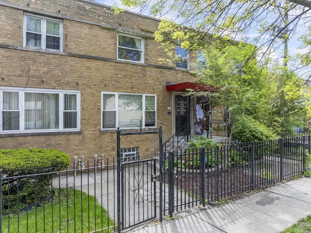 7843 S Yates Blvd, Chicago, IL 60649 - view of property with brick siding and a fenced front yard