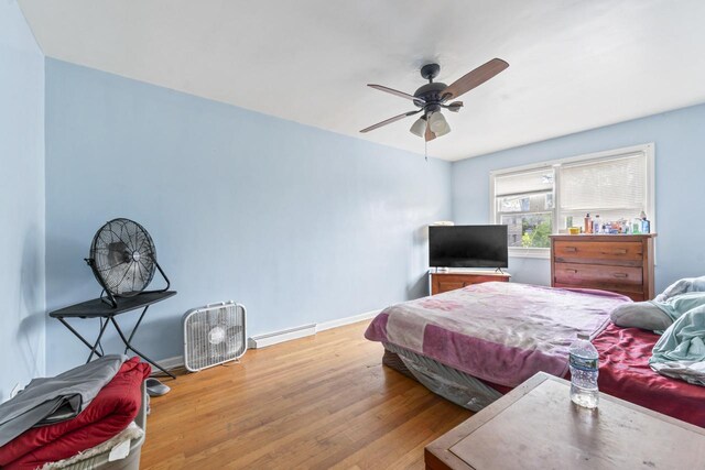 7843 S Yates Blvd, Chicago, IL 60649 - bedroom with a baseboard radiator, wood finished floors, baseboards, and a ceiling fan