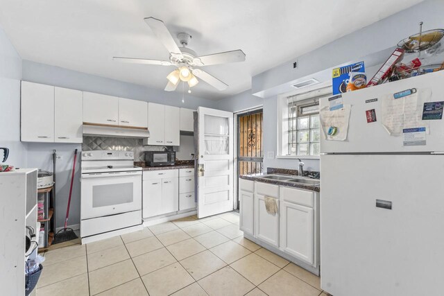 7843 S Yates Blvd, Chicago, IL 60649 - kitchen featuring white appliances, under cabinet range hood, a sink, white cabinets, and a ceiling fan