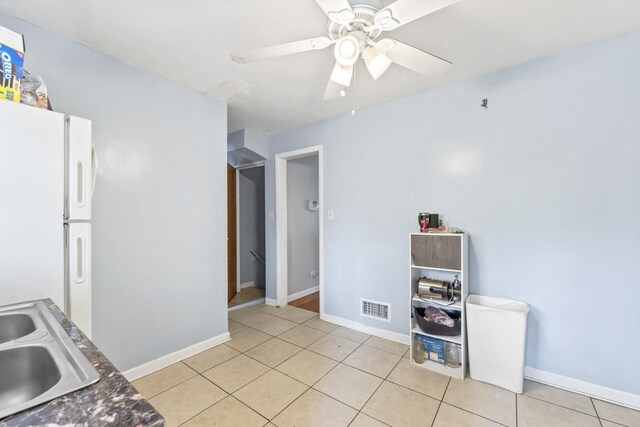 7843 S Yates Blvd, Chicago, IL 60649 - kitchen with a sink, light tile patterned flooring, a ceiling fan, and freestanding refrigerator