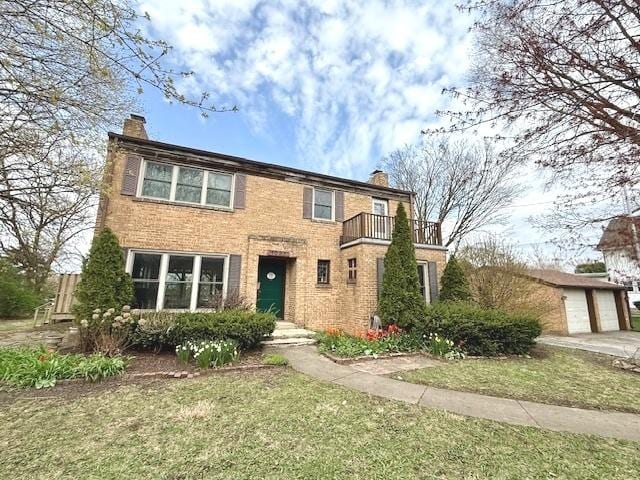 1027 Dekalb Ave, Sycamore, IL 60178 - view of front of property featuring a balcony, a chimney, an outbuilding, and a garage