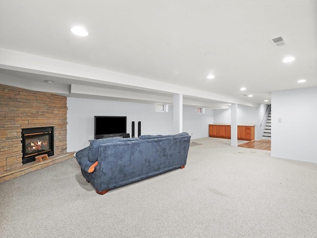 3405 N Osage Ave, Chicago, IL 60634 - carpeted living area featuring stairs, a stone fireplace, and recessed lighting