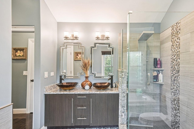 1 Churchill Ct, South Elgin, IL 60177 - bathroom featuring double vanity, a stall shower, baseboards, and wood finished floors