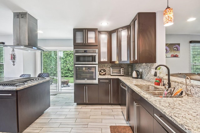1 Churchill Ct, South Elgin, IL 60177 - kitchen featuring island exhaust hood, appliances with stainless steel finishes, dark brown cabinets, light stone counters, and recessed lighting