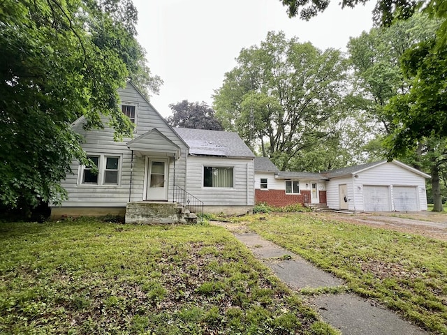 103 W 2nd St, Broadlands, IL 61816 - bungalow with a front yard, a garage, and driveway