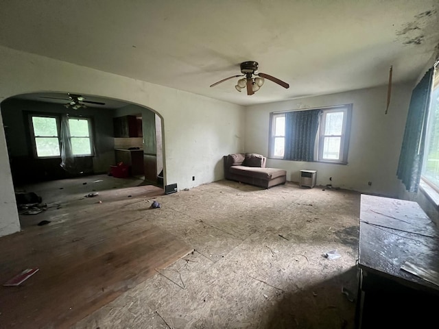 103 W 2nd St, Broadlands, IL 61816 - living area with ceiling fan and arched walkways