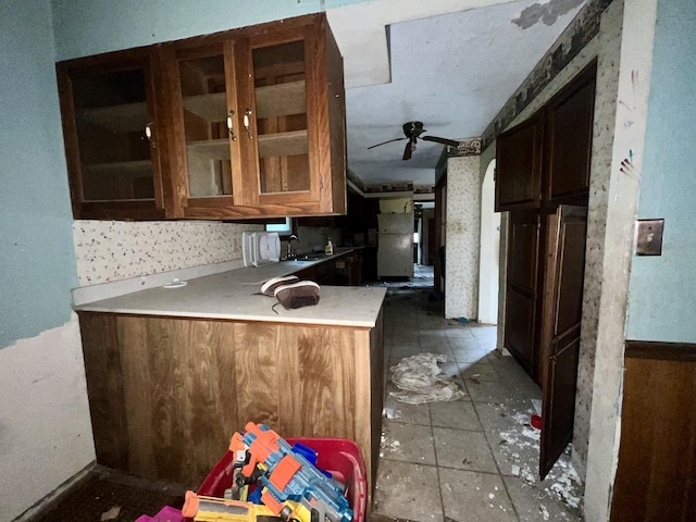 103 W 2nd St, Broadlands, IL 61816 - kitchen with a ceiling fan, glass insert cabinets, light countertops, a sink, and a peninsula