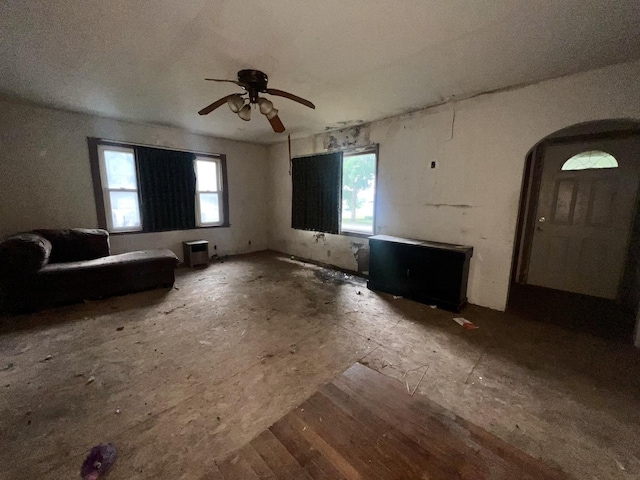103 W 2nd St, Broadlands, IL 61816 - unfurnished living room featuring arched walkways and ceiling fan