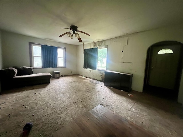 103 W 2nd St, Broadlands, IL 61816 - unfurnished living room featuring a ceiling fan and arched walkways