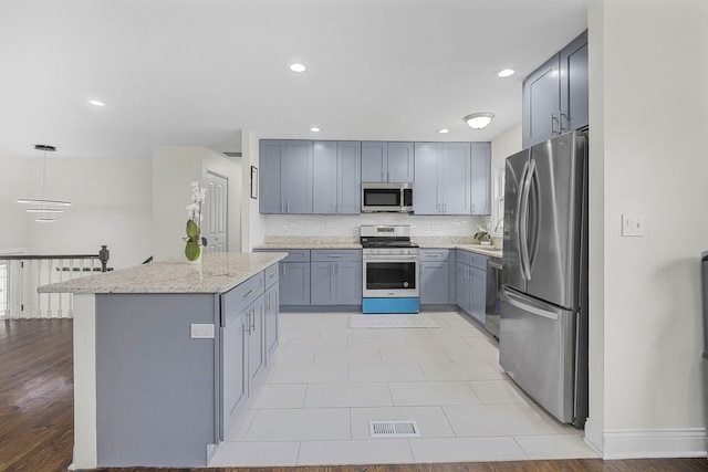 1810 Portsmouth Ln, Schaumburg, IL 60194 - kitchen with appliances with stainless steel finishes, gray cabinetry, backsplash, baseboards, and recessed lighting