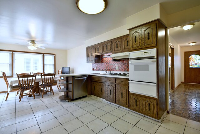 4732 N Anthon Ave, Chicago, IL 60656 - kitchen featuring white oven, a warming drawer, stainless steel dishwasher, a peninsula, and a ceiling fan