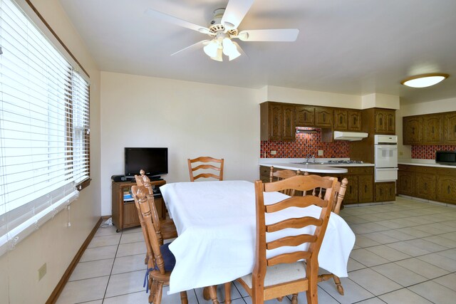 4732 N Anthon Ave, Chicago, IL 60656 - dining space with light tile patterned flooring, a ceiling fan, and baseboards