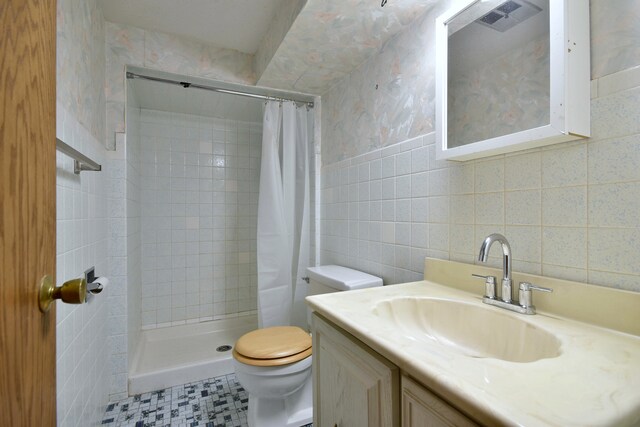 4732 N Anthon Ave, Chicago, IL 60656 - full bathroom with tile walls, toilet, tiled shower, vanity, and wallpapered walls
