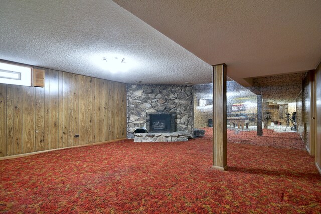 4732 N Anthon Ave, Chicago, IL 60656 - basement featuring a stone fireplace, a textured ceiling, carpet flooring, and wood walls