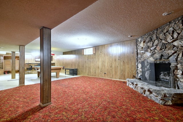 4732 N Anthon Ave, Chicago, IL 60656 - below grade area featuring wood walls, a fireplace, carpet, and a textured ceiling
