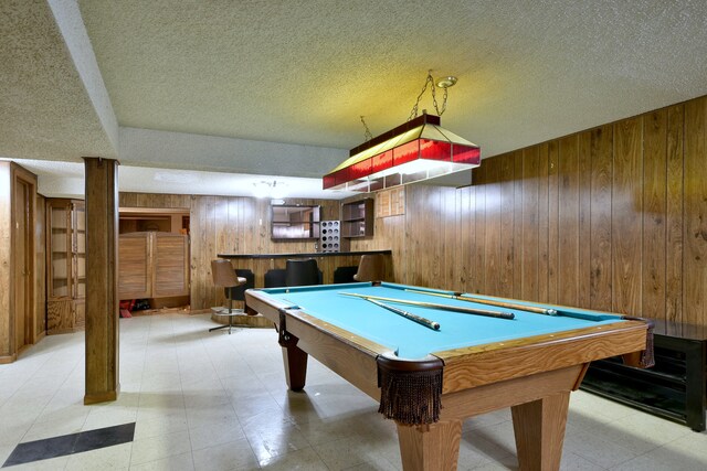 4732 N Anthon Ave, Chicago, IL 60656 - playroom with wood walls, bar, a textured ceiling, and pool table