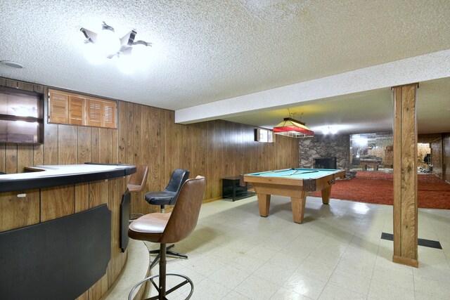 4732 N Anthon Ave, Chicago, IL 60656 - recreation room with wood walls, a textured ceiling, pool table, light floors, and bar area