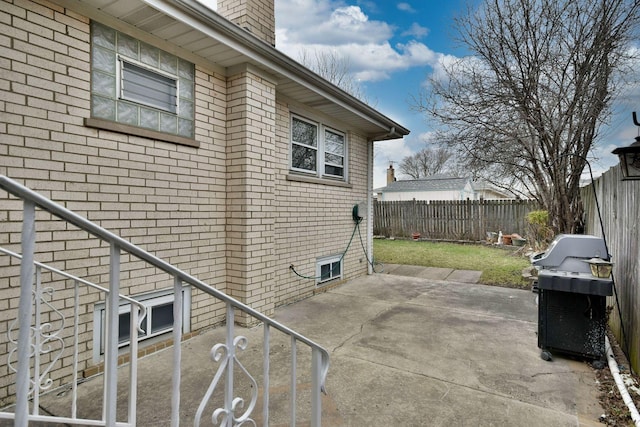 4732 N Anthon Ave, Chicago, IL 60656 - view of side of property with a fenced backyard, a chimney, brick siding, and a patio