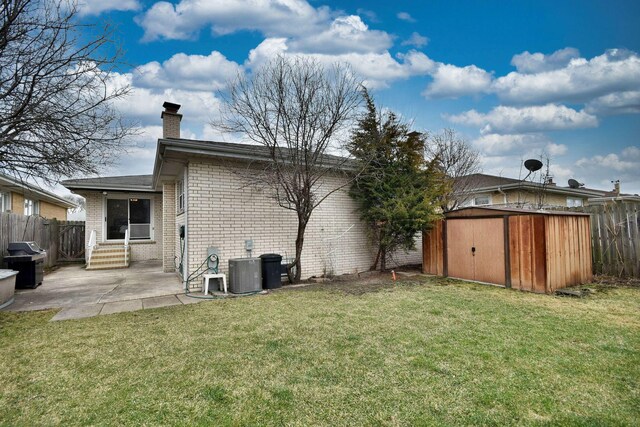 4732 N Anthon Ave, Chicago, IL 60656 - rear view of house with a patio area, brick siding, a chimney, entry steps, and central AC unit