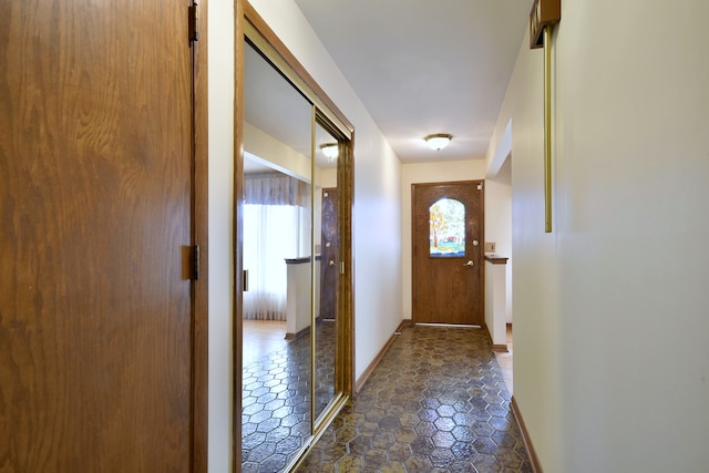 4732 N Anthon Ave, Chicago, IL 60656 - doorway featuring baseboards and dark stone finish floors